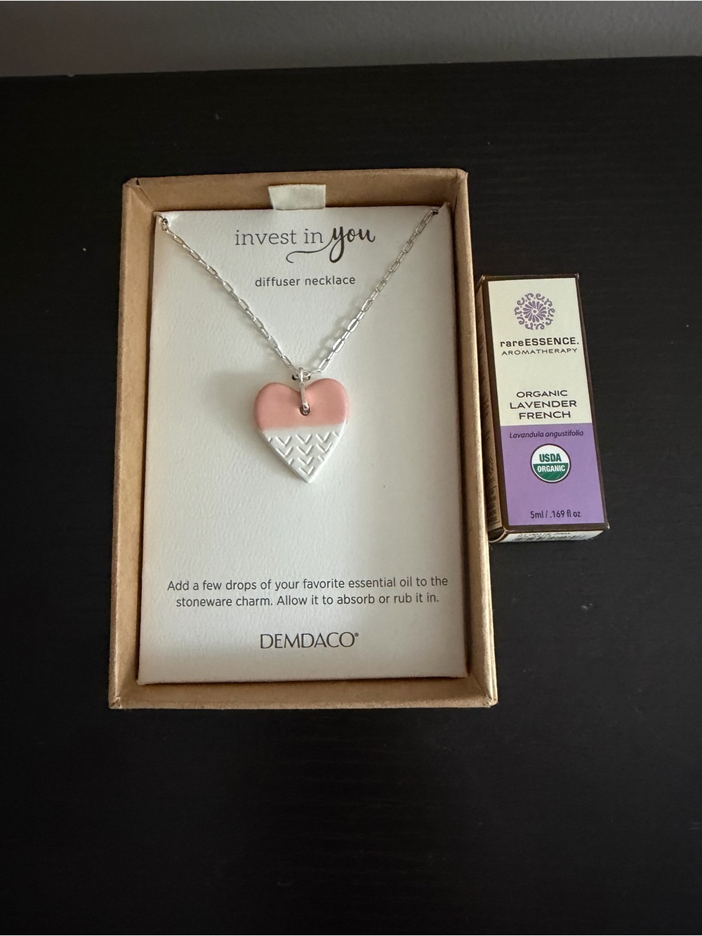 The Demdaco "Invest in You" pink stoneware heart diffuser necklace